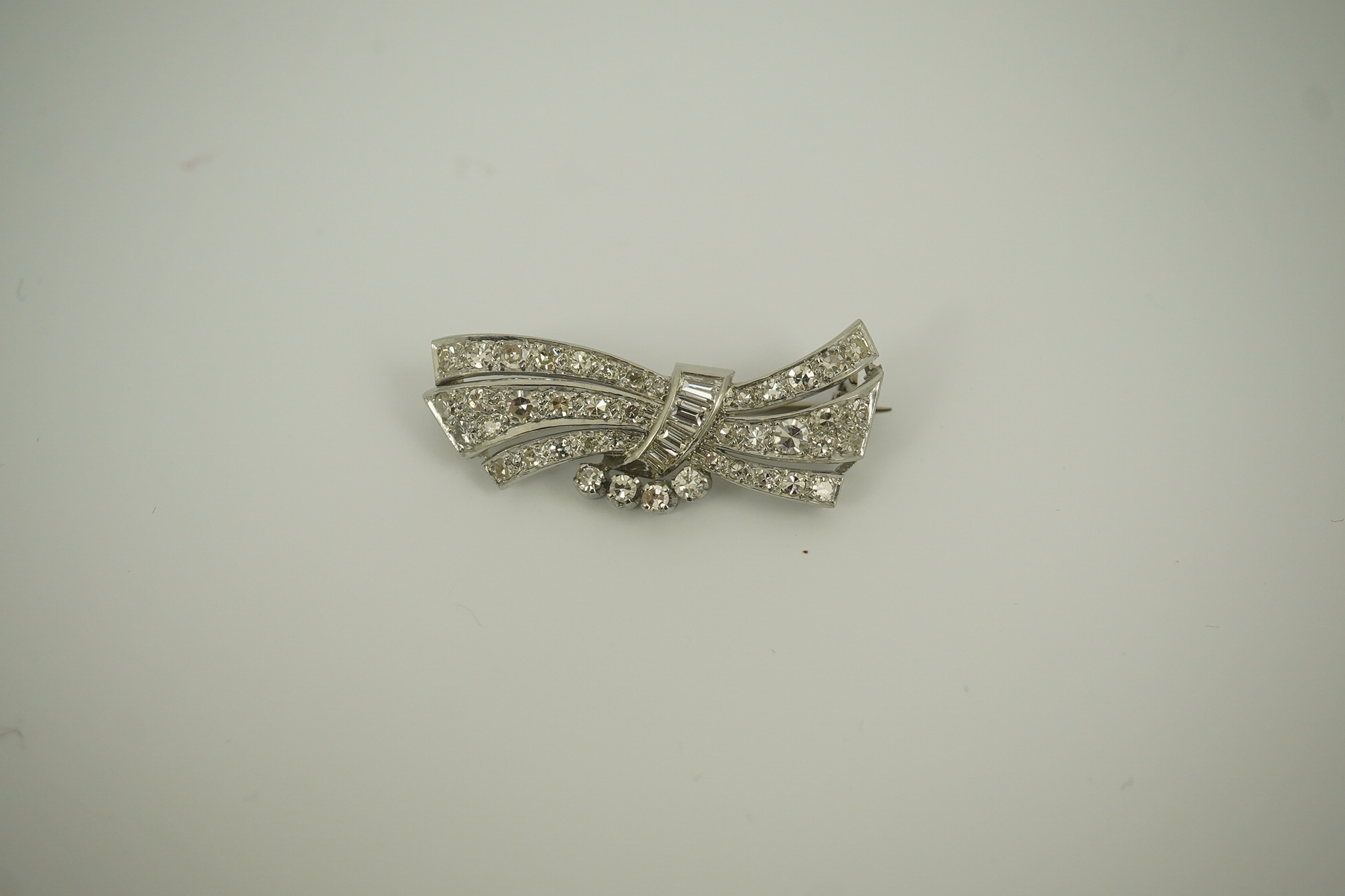 A mid 20th century platinum? and diamond cluster scroll brooch